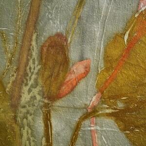 May include: A textile fabric featuring a botanical print with muted gray background tones and organic shapes in shades of mustard yellow, burnt orange, and deep brown. The design displays plant stems and leaves with the text Florich Studio.