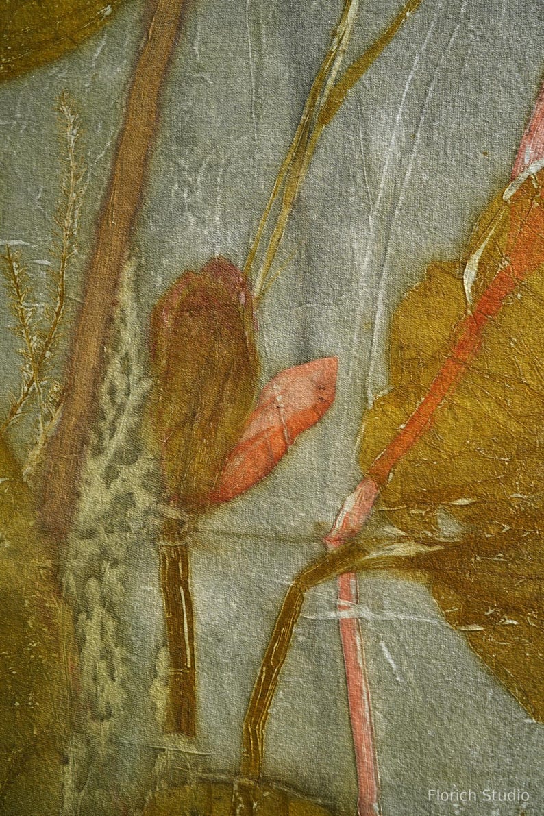 May include: A textile fabric featuring a botanical print with muted gray background tones and organic shapes in shades of mustard yellow, burnt orange, and deep brown. The design displays plant stems and leaves with the text Florich Studio.