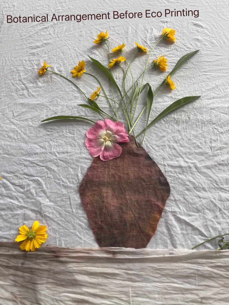 May include: A botanical arrangement on white fabric featuring a brown fabric vase shape, a large pink flower, and several small yellow flowers. The text "Botanical Arrangement Before Eco Printing" is printed at the top of the white fabric background.