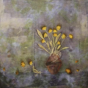 May include: A square textile piece featuring a botanical print with a mottled purple and green background. A central brown vase holds a bouquet of pressed yellow flowers and green stems. Additional small yellow flowers are scattered below.