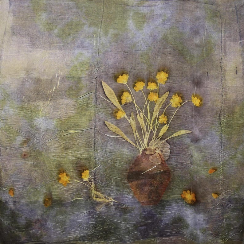 May include: A square textile piece featuring a botanical print with a mottled purple and green background. A central brown vase holds a bouquet of pressed yellow flowers and green stems. Additional small yellow flowers are scattered below.