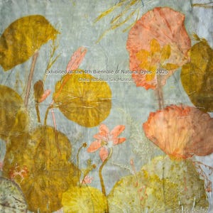 May include: A square textile piece featuring botanical prints of yellow and orange leaves and flowers on a pale grey background. The text reads: Exhibited at the 4th Biennale of Natural Dyes &middot; 2025 China National Silk Museum and Florich Studio.