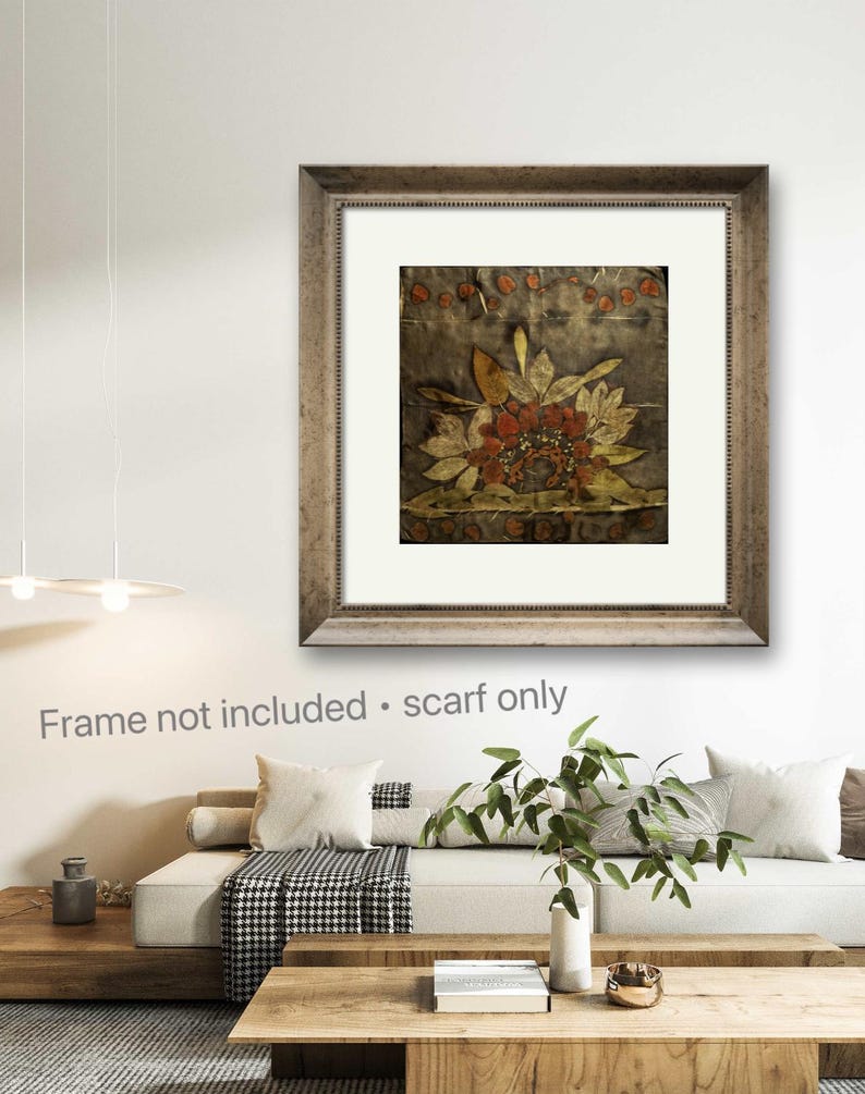 May include: A square scarf featuring a dark, muted background with a central botanical print of stylized leaves and flowers in shades of rust, gold, and olive green. The design includes a row of small circular motifs along the top edge.