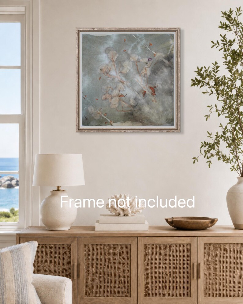 May include: A square wall art print featuring a botanical print with muted grey, green, and rust-colored leaf impressions on a textured background. The artwork is displayed in a light-colored frame, with the text Frame not included visible.