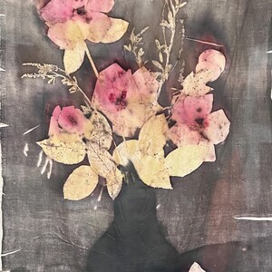 May include: A still life image of a bouquet of pink flowers and yellow leaves in a dark vase. The flowers are pressed onto a dark gray background, creating a vintage aesthetic. The image has a soft, textured appearance.