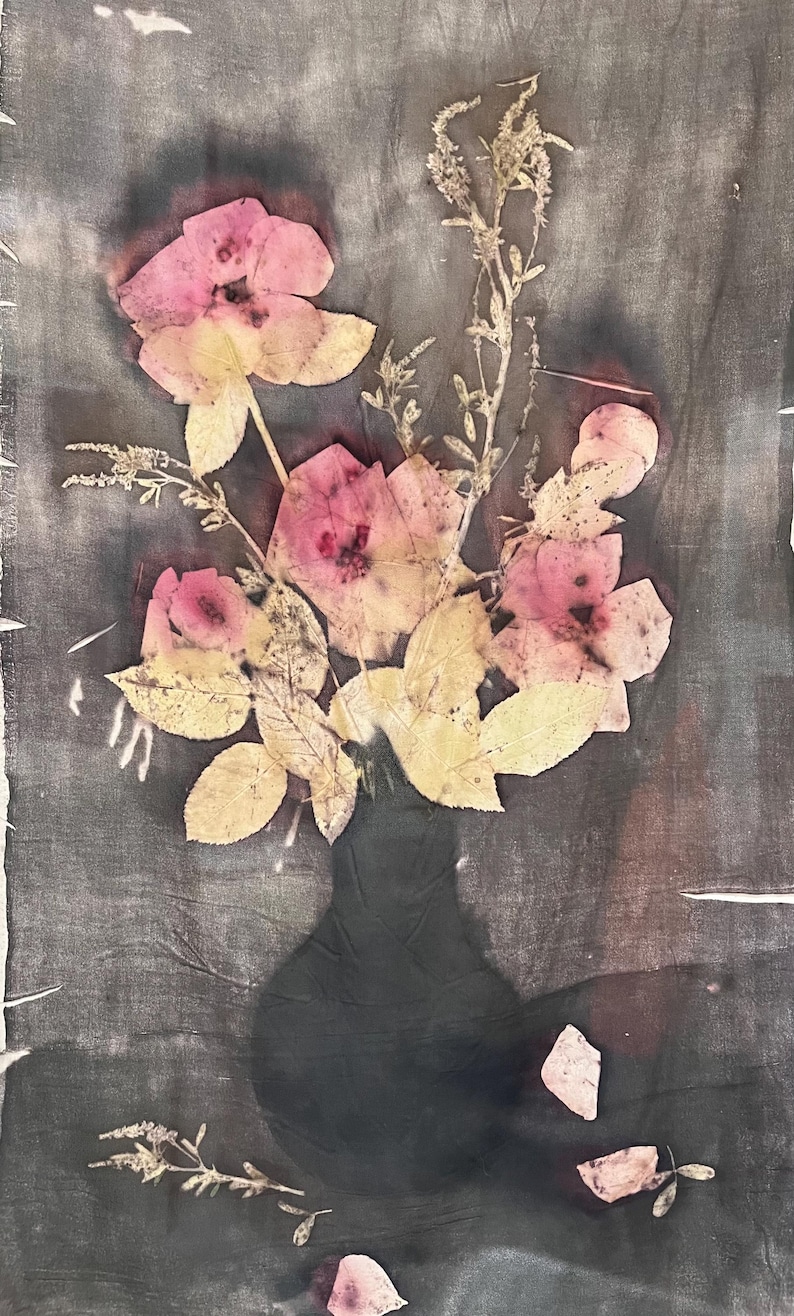 May include: A still life image of a bouquet of pink flowers and yellow leaves in a dark vase. The flowers are pressed onto a dark gray background, creating a vintage aesthetic. The image has a soft, textured appearance.