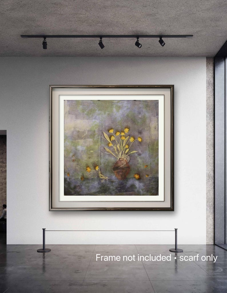 May include: A square textile scarf featuring a printed still life composition of a brown vase filled with yellow flowers. The background displays a mottled, watercolor-style pattern in shades of green, grey, and purple, with loose yellow petals.