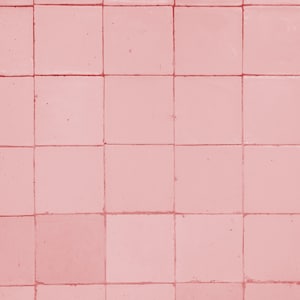 May include: A wall covered in pink square tiles. The tiles are arranged in a grid pattern.
