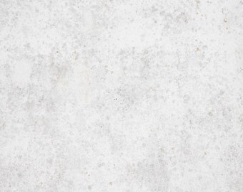 May include: A close-up of a white concrete surface with a speckled texture. The surface has a subtle, uneven pattern of light grey and white spots.
