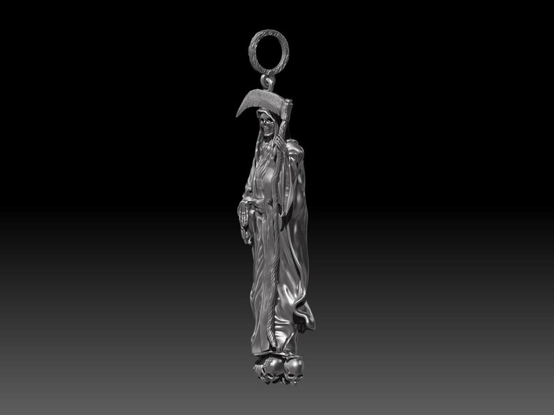 May include: A silver-colored pendant depicting the Grim Reaper, holding a scythe. The figure is draped in a hooded cloak and stands atop three skulls. The pendant has a ring at the top for attachment.