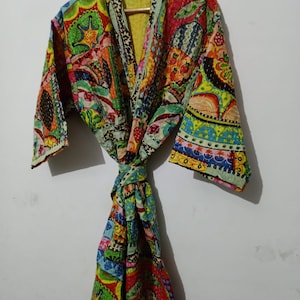 May include: A colorful, patchwork-style robe with a tie belt. The robe is made of cotton and has a paisley print.