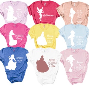 May include: Nine different t-shirts featuring Disney princess silhouettes with humorous text. The shirts are in various colors, including pink, blue, yellow, white, and red.