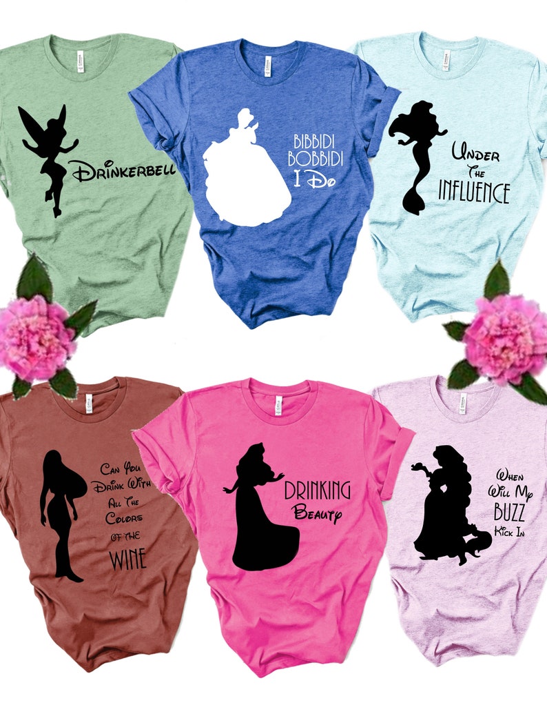 May include: Six different t-shirts featuring Disney princesses with humorous sayings. The shirts are in various colors, including green, blue, pink, brown, and purple. The sayings include "Drinkerbell", "Bibbidi Bobbidi I Do", "Under the Influence", "Can You Drink With All the Colors of the Wine", "Drinking Beauty", and "When Will My Buzz Kick In".