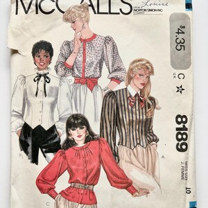May include: Vintage McCall's sewing pattern for blouses, size 10, pattern number 8189. The pattern features four illustrations of women wearing different blouses with puffed sleeves.