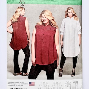 May include: Simplicity sewing pattern 8140 for sizes 18W-24W. The envelope features illustrations and photographs of sleeveless and long-sleeve tunic tops with button-front plackets, mandarin collars, and textured shoulder yokes, paired with slim-fit trousers.