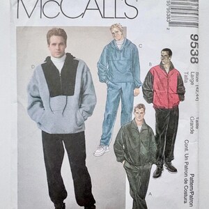May include: A McCall's 9538 sewing pattern envelope featuring illustrations of four different jacket and trouser outfits. The designs include a light grey and black pullover, a solid light blue set, a red and black jacket with trousers, and a dark green set.