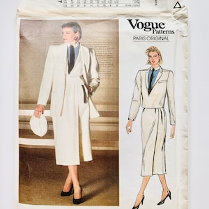 May include: Vogue Patterns Paris Original sewing pattern number 1447 for a white suit with a skirt and jacket. The pattern is designed by Christian Dior.