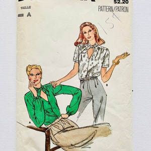 May include: Vintage sewing pattern for a blouse with a tie neck. The pattern is from Butterick and is number 6958. The pattern is for size A and costs £2.20.