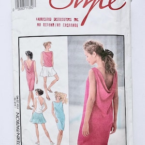 May include: A vintage sewing pattern packet with the word "Style" in red script. The packet features illustrations of dresses and the text "A (6-18)". The packet is white with a pink dress on the front.