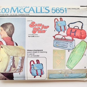 May include: A vintage sewing pattern for making a backpack, a duffel bag, and a travel bag. The pattern is from McCall's and is number 5651. The pattern includes instructions for making a backpack with a lesson sheet on learning to use an iron-on transfer.