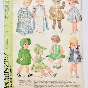 May include: A vintage sewing pattern for making doll clothes. The pattern is for McCall's 2157 and includes instructions for making dresses, coats, and hats for dolls. The pattern is for dolls that are 8 1/2 to 20 inches tall.