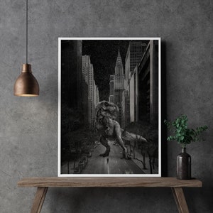 May include: A black and white photograph of a Tyrannosaurus Rex standing in the middle of a city street. The dinosaur is looking to the left, and there are buildings and a starry sky in the background.