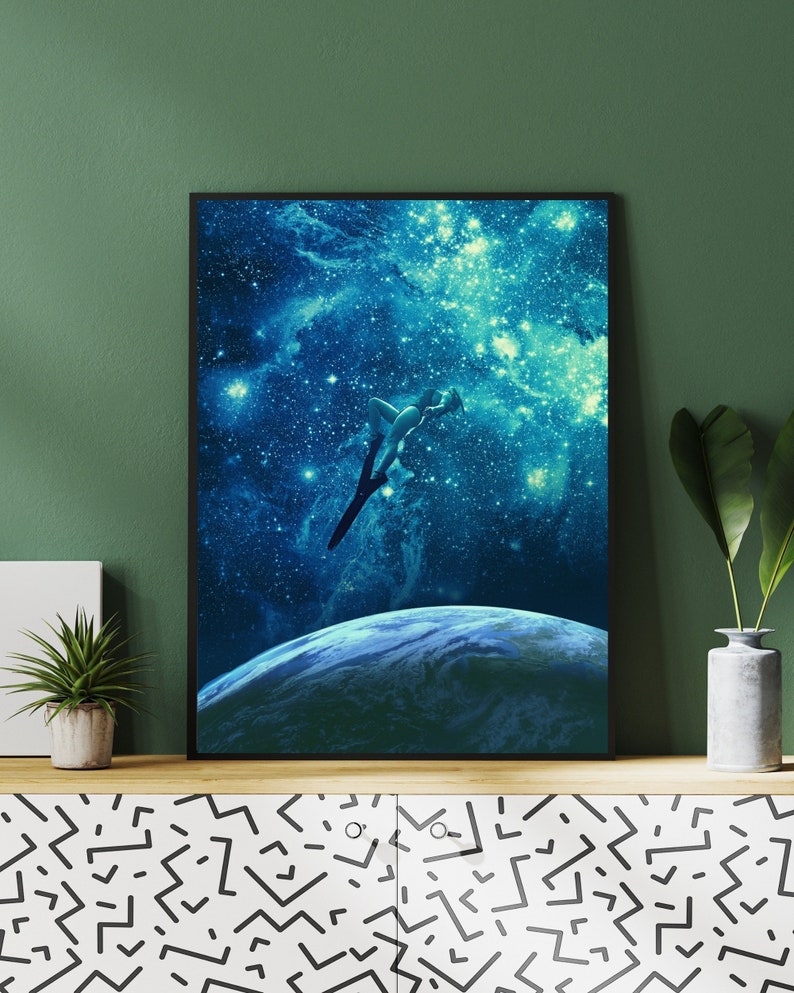 May include: A digital art print featuring a silhouette of a person jumping into a blue and green galaxy with stars. The person is facing away from the viewer and is in mid-air. The galaxy is filled with stars and a planet is visible in the distance.