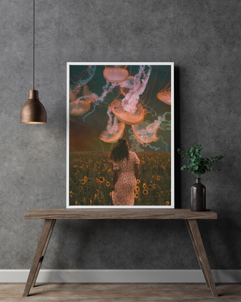 May include: A woman in a white dress walks through a field of sunflowers with a group of jellyfish floating above her. The jellyfish are pink and white and have long tentacles.
