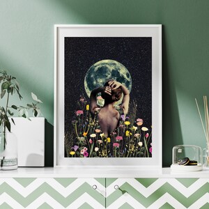 May include: A woman stands in a field of flowers, looking up at a full moon in a starry night sky. The woman's back is to the viewer, and her arms are raised above her head. The moon is a pale green color, and the stars are white.