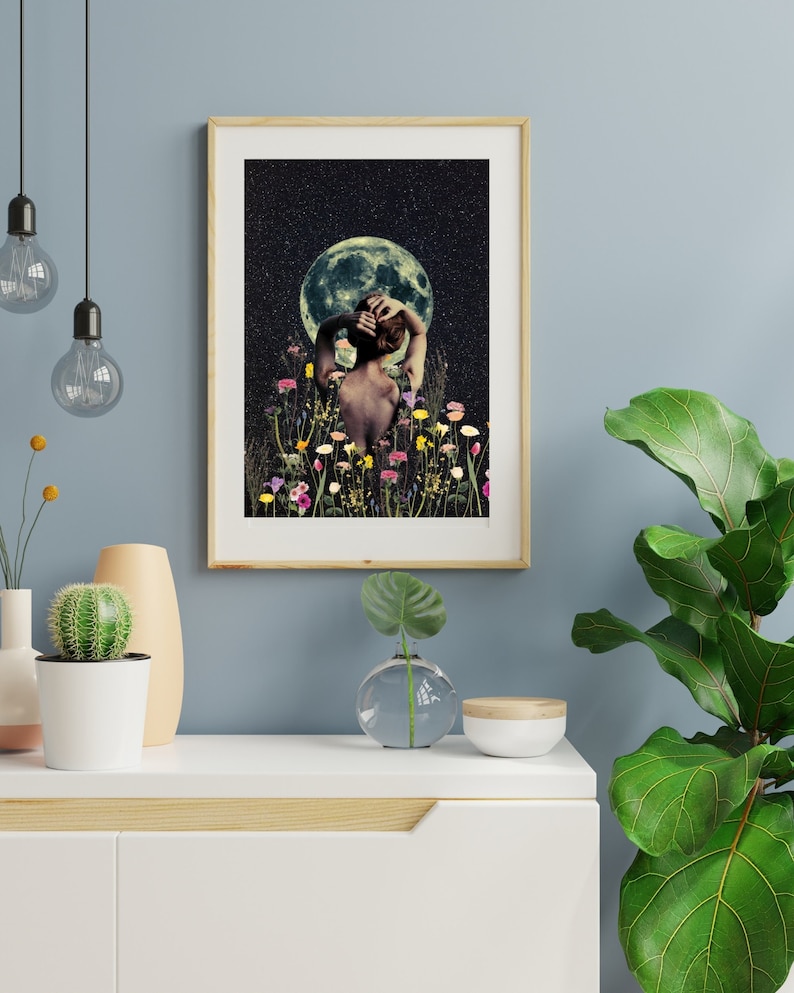 May include: A woman stands in a field of flowers, looking up at a full moon in a starry night sky. The woman is wearing a simple white dress and has her hair pulled back. The flowers are a variety of colors, including pink, purple, yellow, and white.
