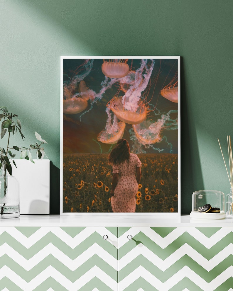 May include: A woman in a floral dress walks through a field of sunflowers with a group of jellyfish floating above her. The jellyfish are a pale orange color with long, trailing tentacles.