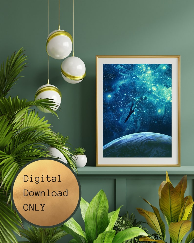 May include: A digital download of a print featuring a silhouette of a person diving into a galaxy of stars. The print is framed in gold and displayed on a shelf with plants.