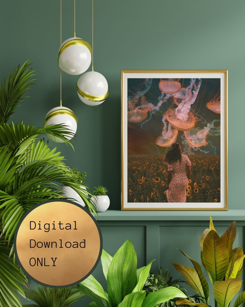 May include: A digital download print of a woman walking through a field of sunflowers with jellyfish floating in the sky above her. The print has a gold frame and is hanging on a green wall.