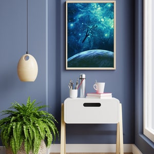 May include: A white nightstand with a drawer and wooden legs. A framed print of a spaceship flying through a galaxy with stars and a planet in the background is hanging on the wall behind the nightstand. A green fern plant is on the floor next to the nightstand.
