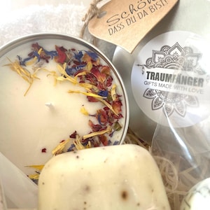 May include: A gift basket with a white candle with dried flower petals, a bar of soap, a small tin with a mandala design and the text "Traumf&auml;nger Gifts Made With Love", and a heart-shaped tag with the text "Sch&ouml;n, dass du da bist!"