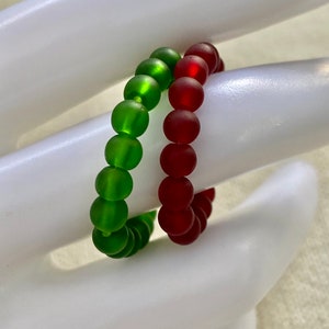 A pair of Red and Green Sea Glass Stretch Rings