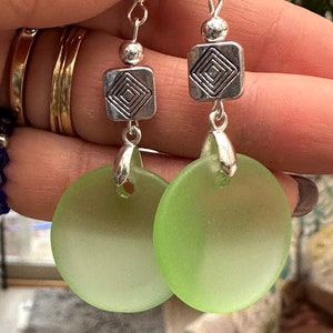 Hermosos aretes de vidrio marino con forma de moneda cóncava de color verde peridoto y cuentas cuadradas