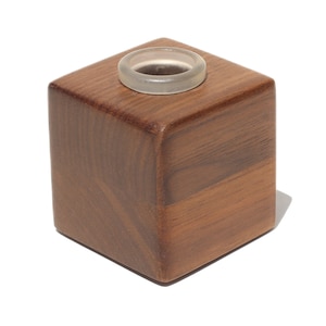 May include: A wooden square-shaped box with a clear plastic insert in the center. The box is made of dark wood with a natural grain pattern.