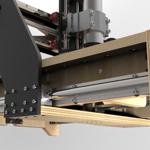 May include: Close-up of a wooden CNC machine with a silver metal rod and a black metal arm. The machine has a wooden frame and a silver metal spindle.