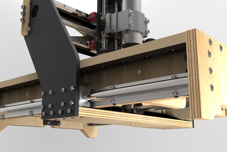 May include: Close-up of a wooden CNC machine with a silver metal rod and a black metal arm. The machine has a wooden frame and a silver metal spindle.