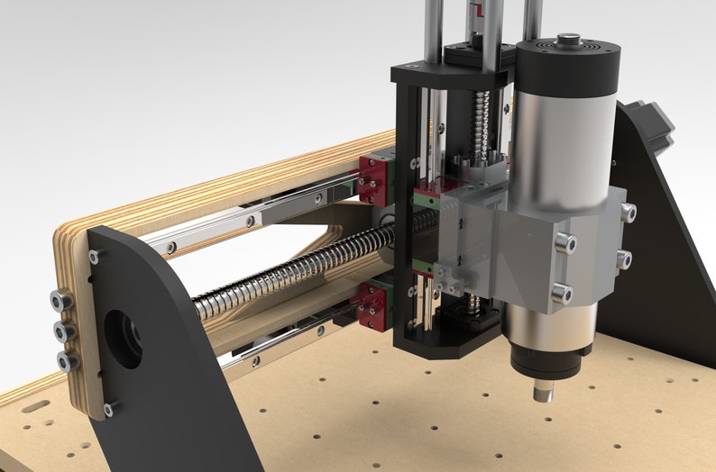 May include: A close-up of a CNC machine with a wooden frame and a black and silver motor. The machine has a metal screw and a linear bearing system. The machine is used for cutting and engraving materials.