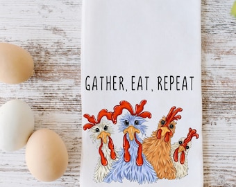 May include: A white kitchen towel with a graphic of four chickens and the text "Gather, Eat, Repeat".