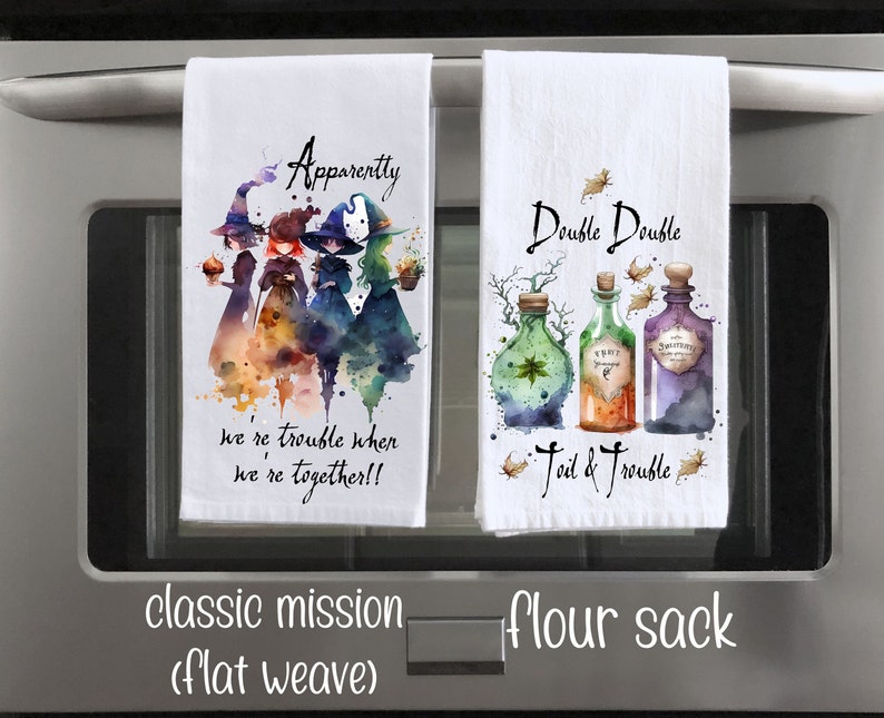 May include: Two kitchen towels with a Halloween theme. The first towel features a watercolor illustration of three witches with the text "Apparently we're trouble when we're together!!". The second towel features a watercolor illustration of three potion bottles with the text "Double Double Foil & Trouble".