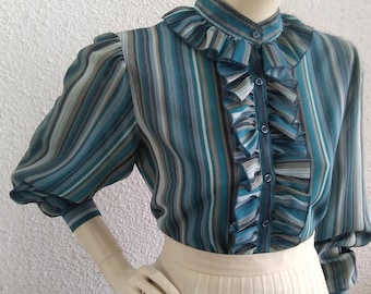 May include: A blue and white striped blouse with a ruffled collar and long sleeves. The blouse has a button-up front and a gathered waist.