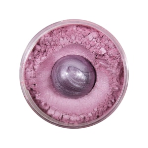 Pu&ograve; includere: Un piccolo contenitore rotondo di pigmento cosmetico rosa in polvere con una sfera metallica viola al centro.