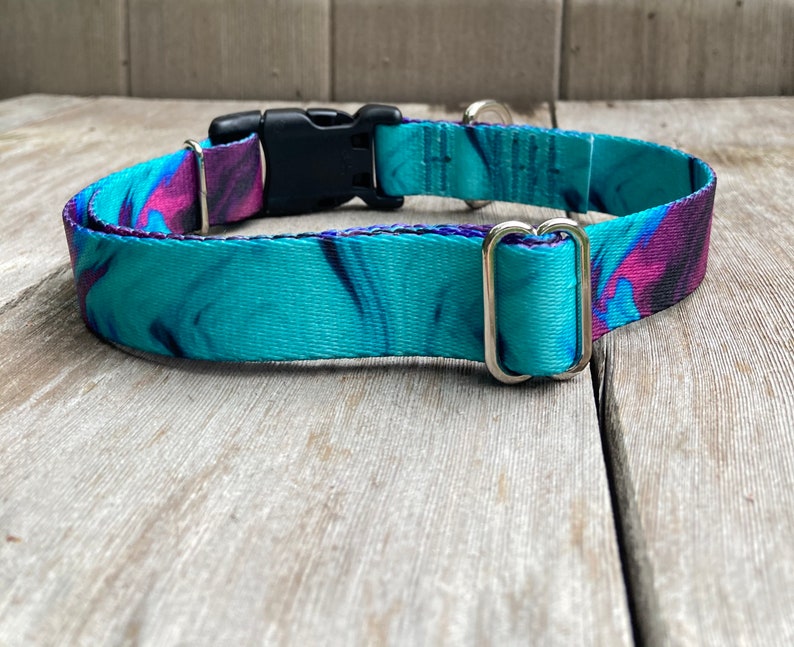 May include: A turquoise and purple patterned dog collar with a black plastic buckle and silver D-rings.