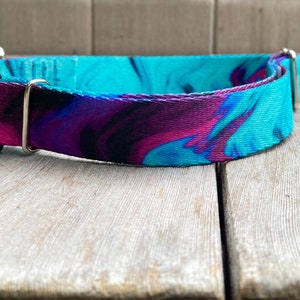 May include: A turquoise, purple, and black marbled dog collar with a black buckle and silver D-ring.