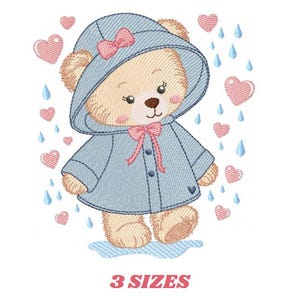 May include: An embroidered design of a teddy bear wearing a blue raincoat and hood, with a pink bow. Pink hearts and blue raindrops surround the bear. The text "3 SIZES" is at the bottom in pink.