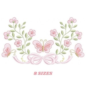 May include: Embroidered design featuring two pink butterflies with green leaves and pink flowers. The design includes a pink bow in the center. The text "8 SIZES" is below the design.