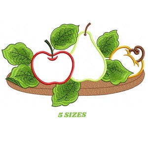May include: An embroidered design featuring a red apple, a green pear, and a golden pumpkin, all outlined in a detailed stitch. Green leaves and the text "5 SIZES" are also included. The design is set on a brown oval base.